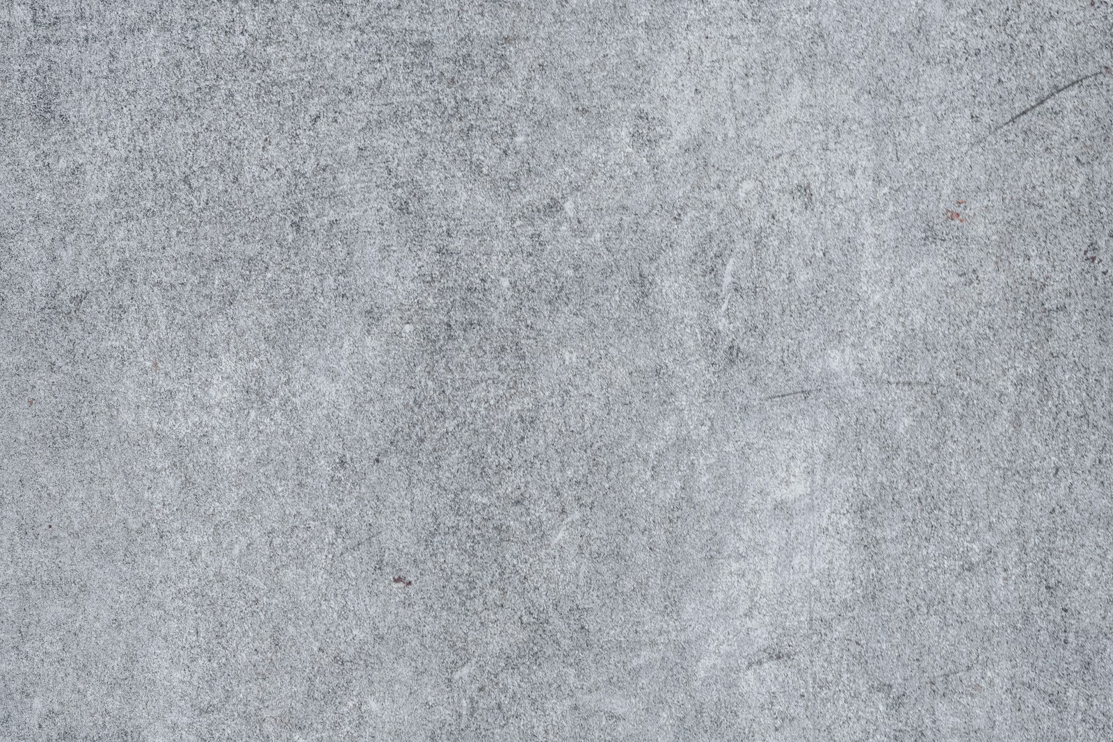 Bare cementitious substrate surface of the kind flooring crews meet at mobilization.